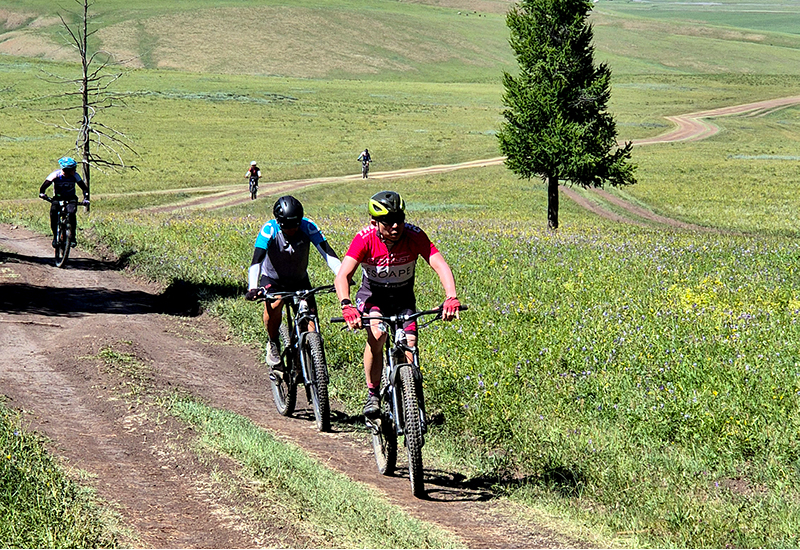 Cycle climbing up to Mongolian hill